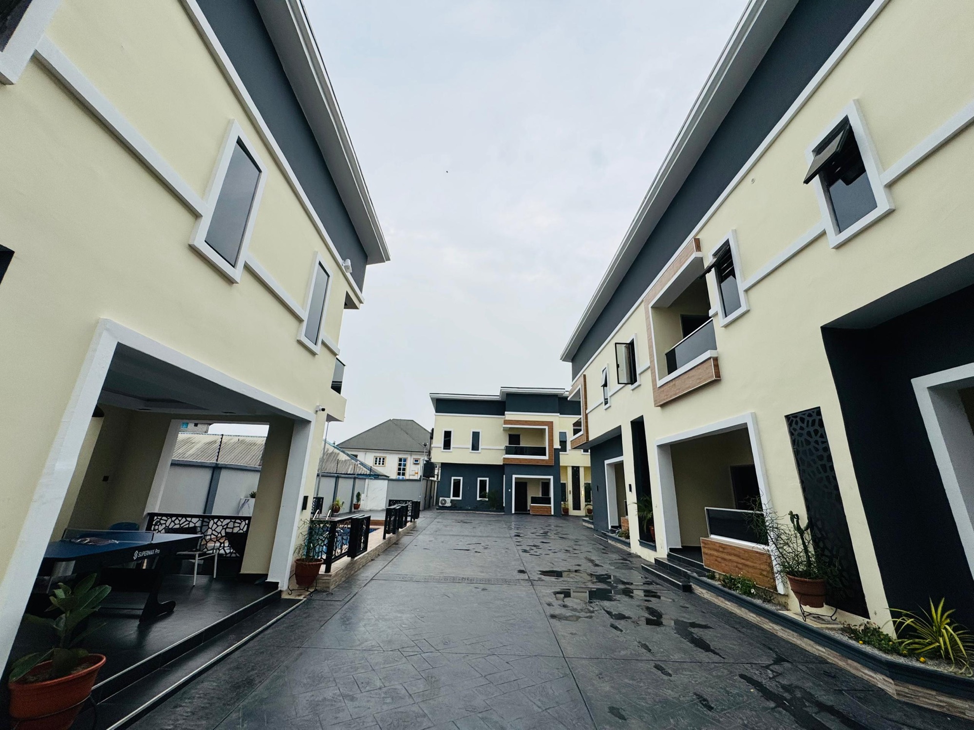 The walkway between the apartment blocks, with a table tennis table under the terrace