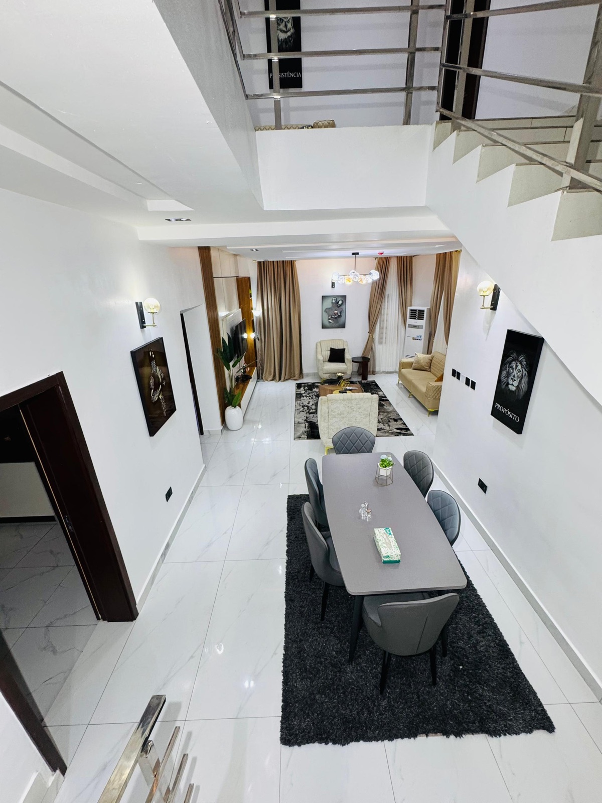 A dining area with framed pictures along the wall